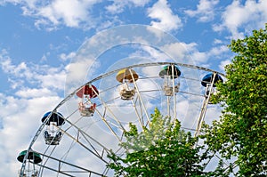Ferris wheel with multi-colored booths. Copy space