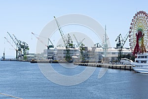 Ferris wheel near shopping and ship yard in Kobe, Japan