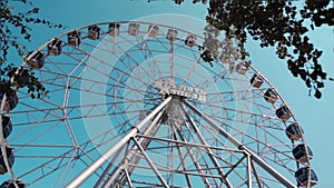 Ferris Wheel Over Blue Sky. Ferris wheel against a blue sky on a sunny day in park. Ferris wheel on the water at sunrise