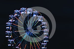 Ferris wheel for panoramic view in amusement park is popular entertaining ride in summer night