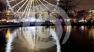 Ferris wheel in Paris Tuileries park over with pool reflection