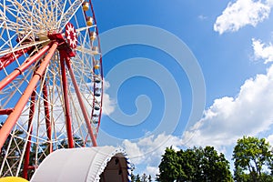 Ferris wheel in the park against the blue sky