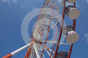 A ferris wheel in the park in Batumi. Brightly colored Ferris wheel against the sky