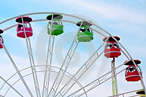 Ferris wheel without people on the blue sky background