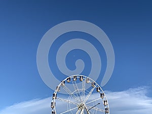 Ferris wheel and plane in the sky.