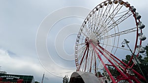 Ferris Wheel in rainy day, amusement park with sad mood concept, 4k video