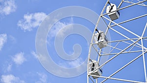 Ferris wheel rotates against sky