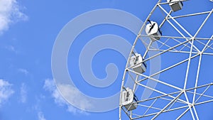 Ferris wheel rotates against sky