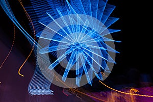 Ferris wheel. Rotating illuminated attraction in amusement park at night.