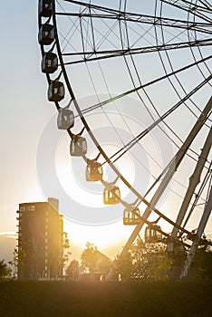 Ferris wheel with the sunset behind photo