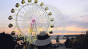 Ferris wheel at sunset on promenade in slowmotion. 1920x1080