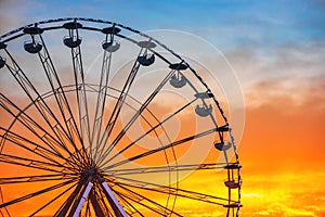 Ferris Wheel with sunset sky and clouds