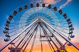Ferris Wheel with sunset sky and clouds