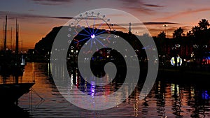 Ferris wheel turning at sunset.