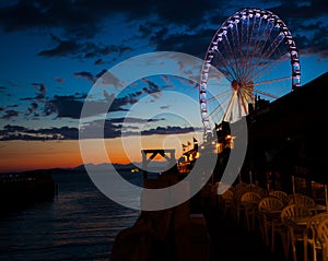 Ferris wheel on the water at sunset