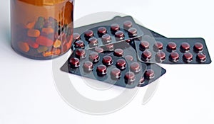 Ferrous Fumarate pills in packs with tablets, capsules, vitamins in brown bottle for treatment iron deficiency anemia disease.