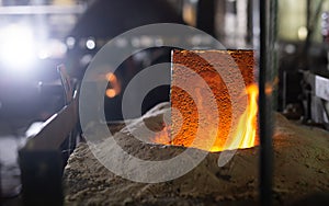 Ferrous metal billet is melted in an induction furnace closeup photo