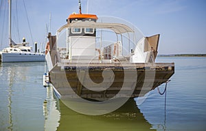 Ferry approaching with open ramp to El Rompido Marina, Spain photo