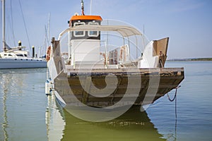 Ferry approaching to El Rompido Marina, Spain photo