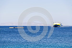 Ferry boat destination Greece, Naxos harbor Cyclades islands. High speed vessel in vast Aegean sea