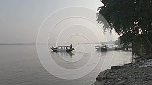 Ferry boat leaving Bauria Ghat with passengers on a sunny winter evening. Kolkata Howrah ferry service on the Ganges