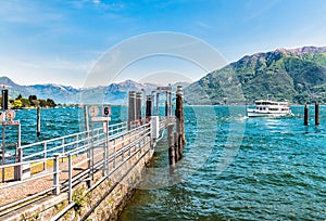 Ferry boat at the pier on the shore of lake Maggiore.