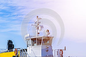 Ferry boat white cabin with big windows. Wing of running bridge of cruise liner. white cruise ship on a blue sky with navigation