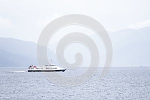 Ferry departure in Scottish sea sailing to island photo
