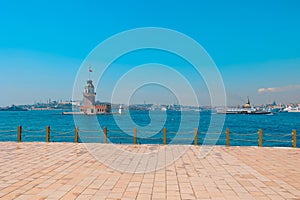 Ferry and Kiz Kulesi aka Maiden's tower with cityscape of Istanbul photo