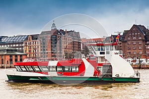 Ferry navigating on the Elbe river in a cold cloudy winter day