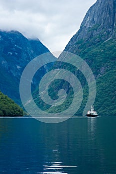 Ferry sailing in the Naeroyfjord in Gudvangen,  Norway
