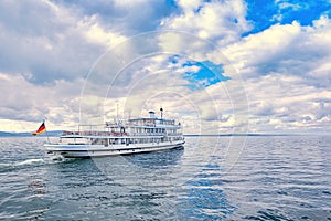 Ferry sails through calm waters under cloudy skies