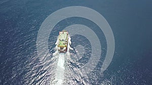 Ferry on the sea, transporting cars: deck of a boat carrying vehicles. Summer sun reflecting off the rippled water