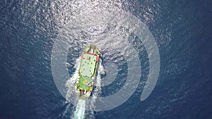 Ferry on the sea, transporting cars: deck of a boat carrying vehicles. Summer sun reflecting off the rippled water