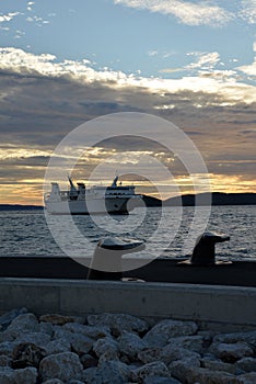 Ferry ship arriving at the Split harbor at sunset