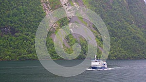 Ferry ship with passengers on Norwegian fjord.