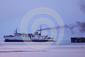 Ferry with smoke coming from stack ,Diesel engine ready to leaving from the harbor
