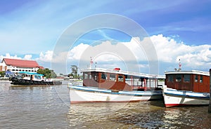 Ferry station and ferry boat on river.