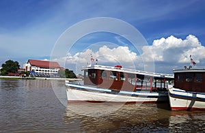 Ferry station and ferry boat on river.