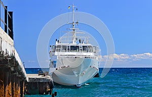 Ferry or tourist cruiser alongside a dock