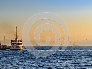 Ferryboat in the bosphorous sea during sunrise photo