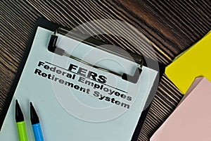 FERS - Federal Employees Retirement System write on a paperwork isolated on Wooden Table photo
