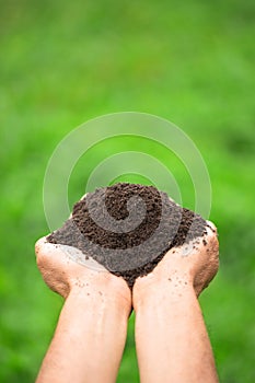 fertile soil in male hands, high-quality black ground in the farmer's garden