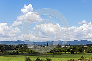 A fertile valley in front of a ridge on a sunny summer day