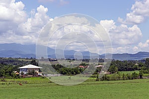 A fertile valley in front of a ridge on a sunny summer day