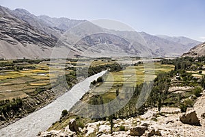 Fertile Wakhan Valley with Panj river near Vrang in Tajikistan. The mountains in the background are the Hindu Kush in Afghanistan