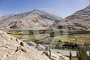 Fertile Wakhan Valley with Panj river near Vrang in Tajikistan. The mountains in the background are the Hindu Kush in Afghanistan