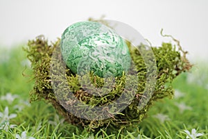 Fertility symbol, easter egg marbled with algae powder, fully organic