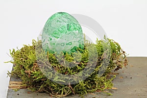 Fertility symbol, easter egg marbled with algae powder, fully organic