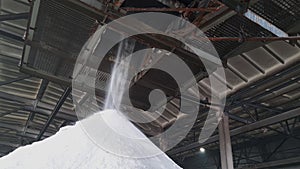 Fertilizers powder pour in a pile inside a warehouse of chemical plant.